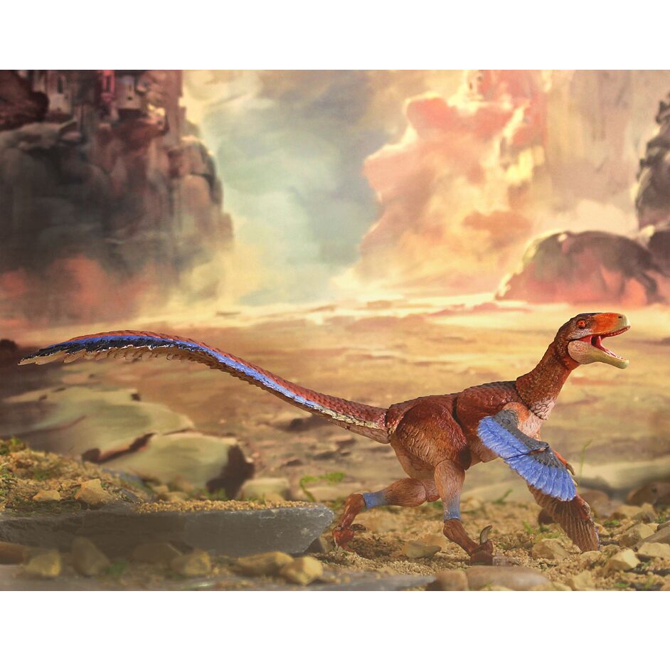 A colourful dromaeosaur model in the landscape.